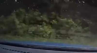 Car merges into cammers lane, and causes a rollover.