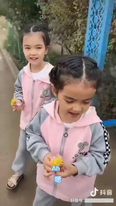 The two Uyghur twins stood by the roadside every day with flowers, waiting for their father to return from 