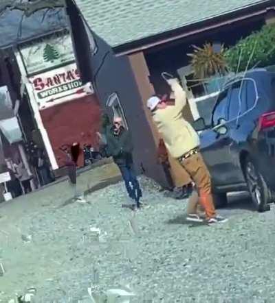 Man tying a Christmas tree to the roof, tied doors too