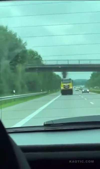 Tow truck fails to retract crane and nails a bridge on the freeway.