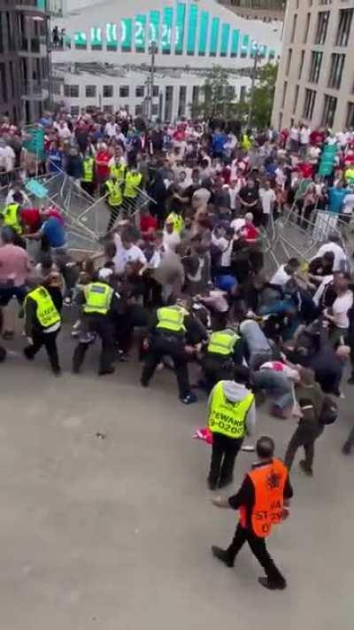 Louts breaking past the Wembley barrier. Honestly embarrassed by the behaviour of these idiots.