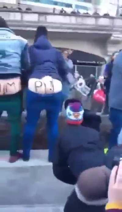 All mooning Trump Tower in unison.