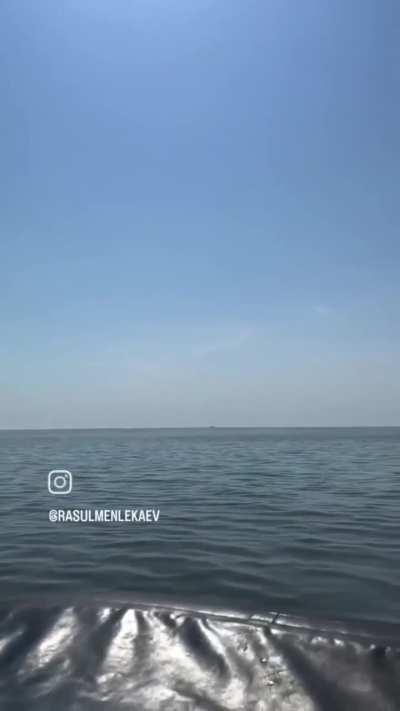 CIV POV: Fishermen film 2 Russian Kalibr Cruise Missiles flying over the Caspian Sea