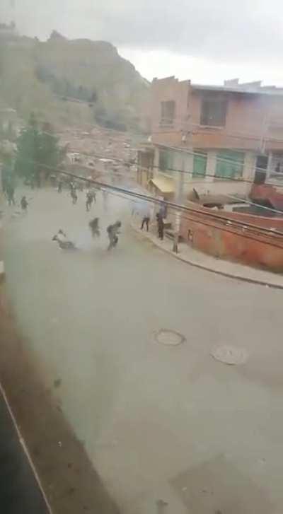 A Protesting Bolivian 'Cocalero' (coca farmer) brings two grenades to a protest. He activates the grenade in his left hand, but mistakenly throws the grenade in his right hand.