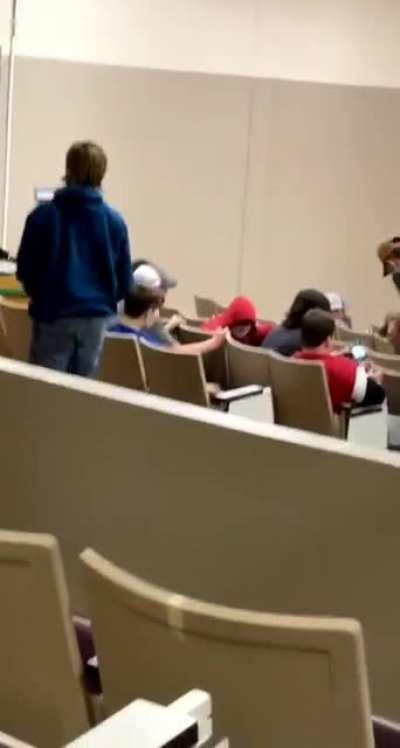 Kid tries to jump over auditorium seat