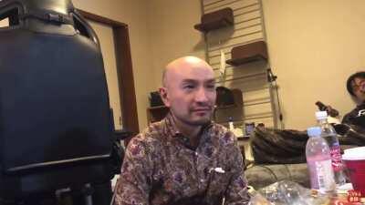 tatsuhiko takimoto listening to puzzle, turns around and then sighs