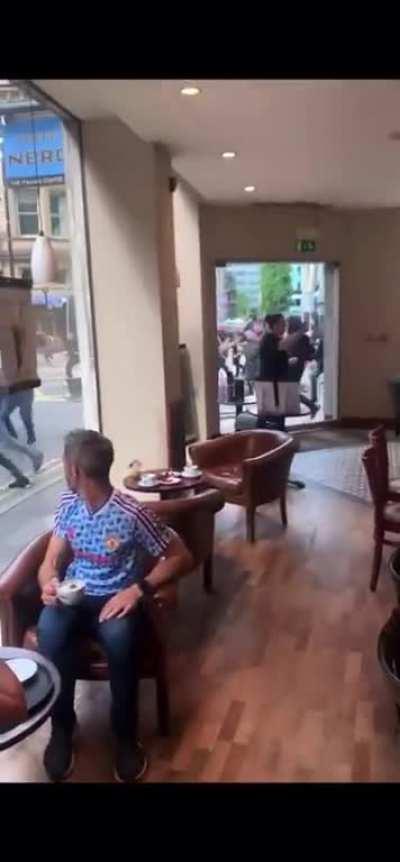 Soccer fans fight each other in the street ahead of their rivalry game.