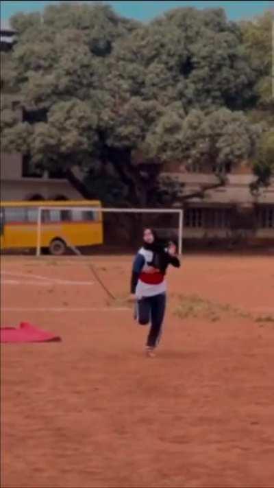 Kalaripayattu demonstration with a Urumi: whip sword by a high school girl in Kerala, India.