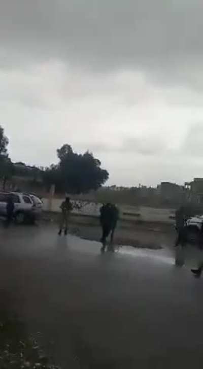 New Syrian rulers (previous rebels) take out an injured man from an ambulance and drag him over steps. According to them he caused a massacre during Assad regime