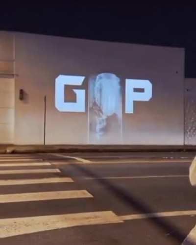 Guardians Of Pedophiles on loop being projected on wall in public