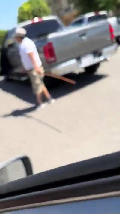 The man with the stick almost made the other driver run into a pole, the rest is history