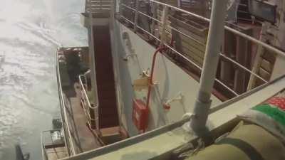 Pirates trying to get on the cargo boat.