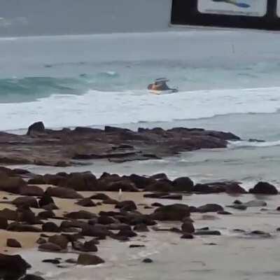 Boat steering into a breaking wave