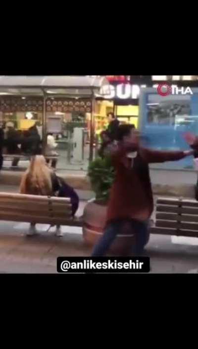 A woman hitting random ppl with her bag