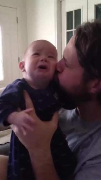 Dad calms blind and deaf son with a kiss