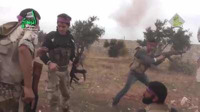 Nour al-Din al-Zinki fighters lay down fire round a corner, including close range RPGs and grenades in Aleppo, Syria (2016)