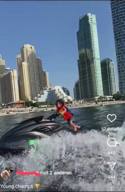 A toddler riding the waves