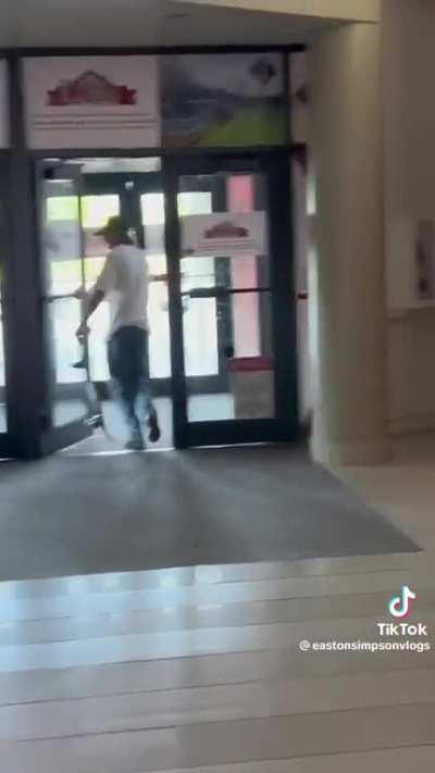 Skateboarding in the mall in front of security