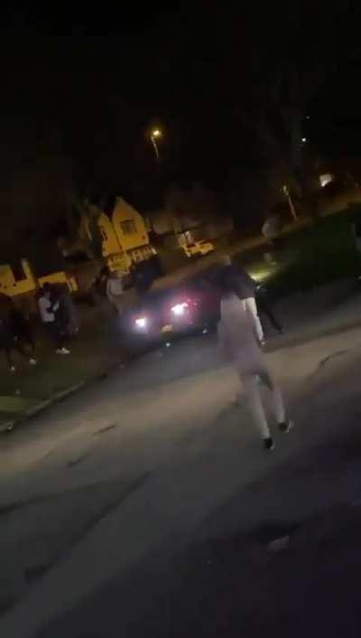 A reversing car seemingly injures a man as it rolls over during a crash following a fight in Bartley Green, Birmingham in the UK