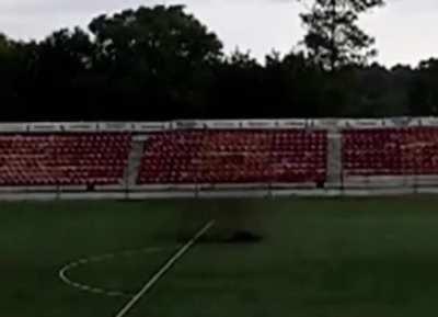 WCGW playing football during a thunderstorm