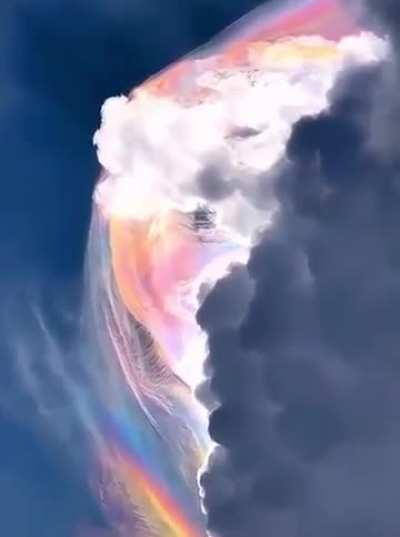 Video with a rare, beautiful natural phenomenon called pileus. Under certain circumstances, a cloud formed as a result of the condensation of cold, moist air begins to refract light, like raindrops in a rainbow.