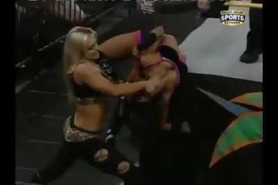 Aksana bending AJ around the ringpost in FCW