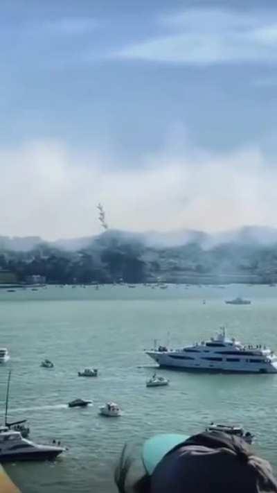 One of the US Navy Blue Angels flying just feet above the surface in San Francisco Bay.