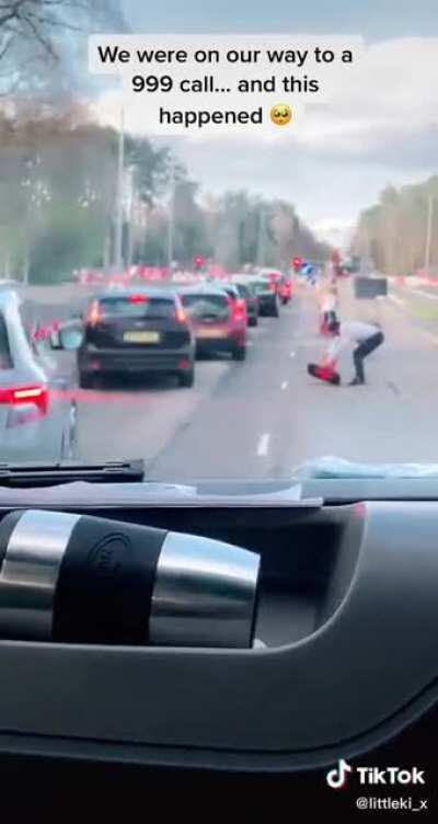 Members of the public helping out an Ambulance