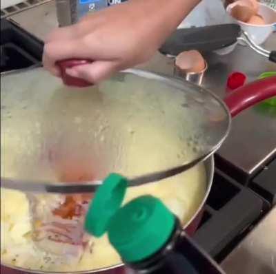 Steak in a frying pan with macaroni , cheese and egg
