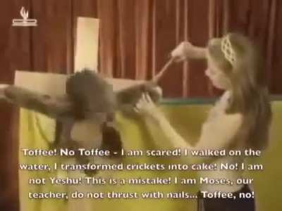 Lady in a bikini top crucifies a monkey puppet