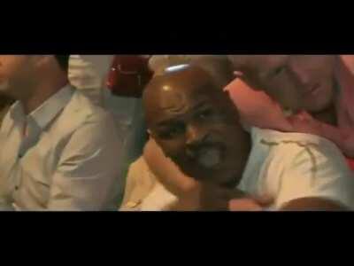 Idiot sneaks up behind Mike Tyson and puts his arms around his neck