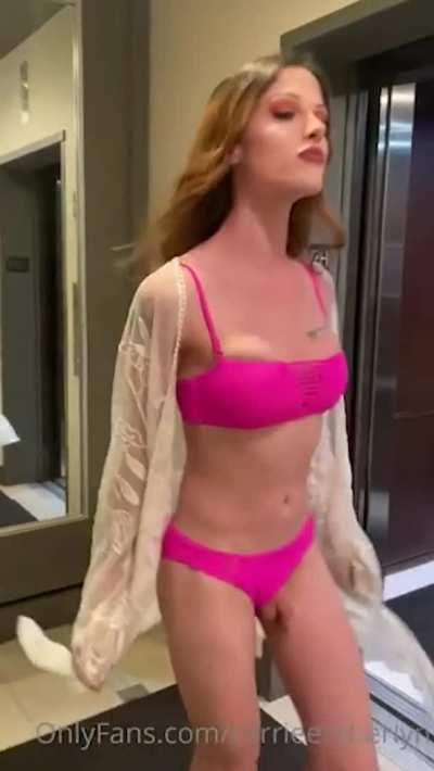 Carrie flashes her cock in a hotel hallway