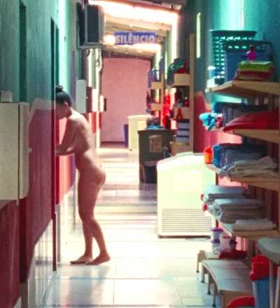 Nataly Rocha walking fully nude through a corridor in brazilian film Motel Destino (2024)