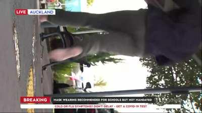 News crew get knocked over onto the ground.