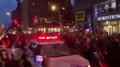 People dancing atop a cop car in NY. Like a scene outta Joker