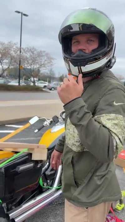 Dude trying to carry a 65 inch Tv on a Motorbike