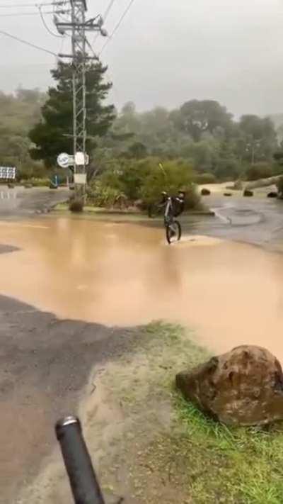 Trying to keep dry wheel-standing through floodwaters