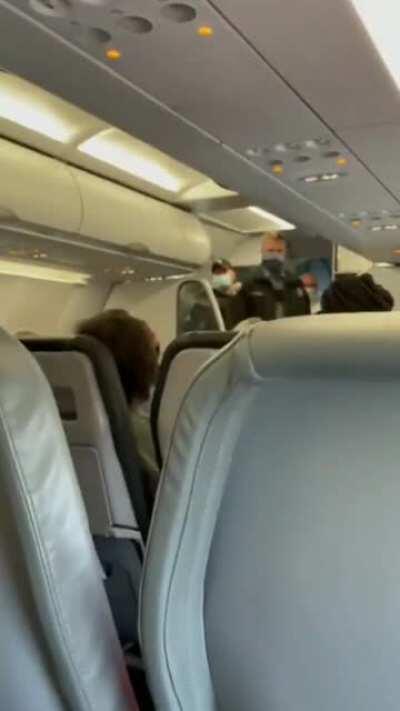 Passenger removed from airplane for refusal to wear face mask.