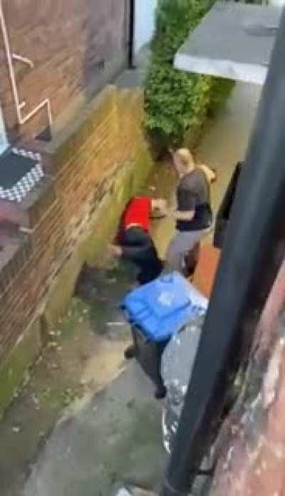 Neighbours fight over Christian cross on gate, ends up with the aggressor knocked out... wife has husbands back on the phone, ride or die.