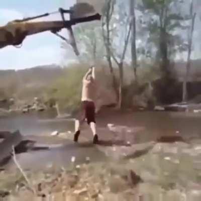 Idiot almost gets thrown off a cliff