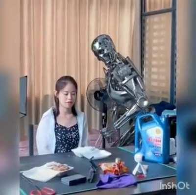 Terminator T-800 helping its human stay healthy by giving her the daily dose of bleach cream she needs.