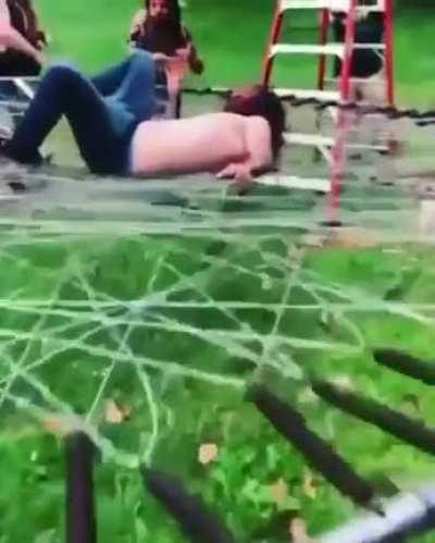 Jumping on a trampoline made of barbed wire