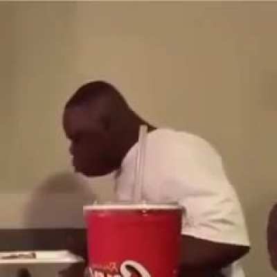 Just a guy enjoying his chicken, with a side of Coke...