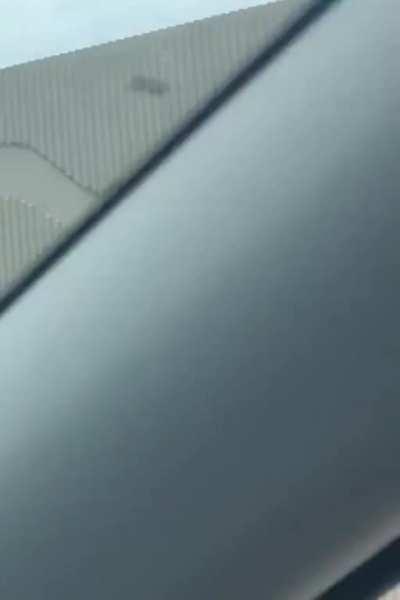 Man holding onto hood of semi, Florida be like