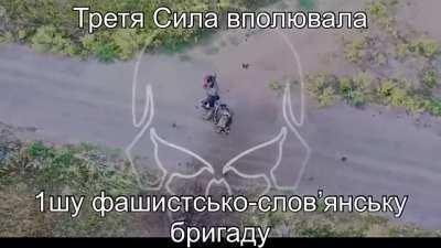 Two Russian soldiers instantly killed by a direct artillery hit while walking down the road.