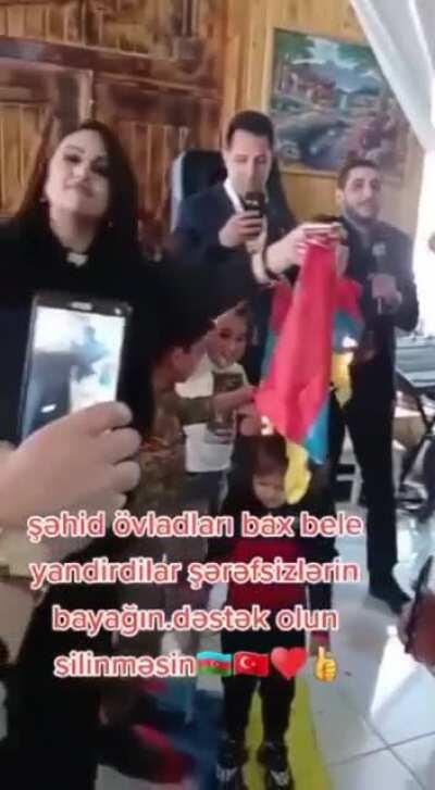How are a group of Azeris are throwing a party, burning Armenian flags dangerously close to children. Notice how some of the flames nearly land on their heads. This is the way hatred against Armenians is being taught while endangering the lives of childre