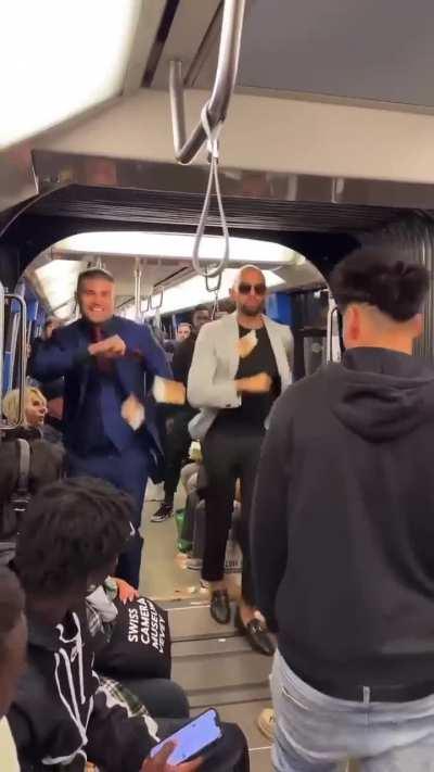 Throwing money and dancing in a busy train.