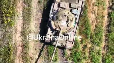 A Ukrainian drone dropping a grenade into the drivers hatch of a disabled Russian t62M (music from source)
