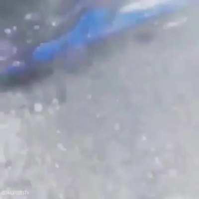 Guy on a snowmobile jet skiing on his pool