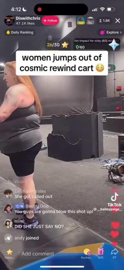 A Disney ride experiences a delay, leading to a woman refusing to remain seated and subsequently being ejected from the attraction.